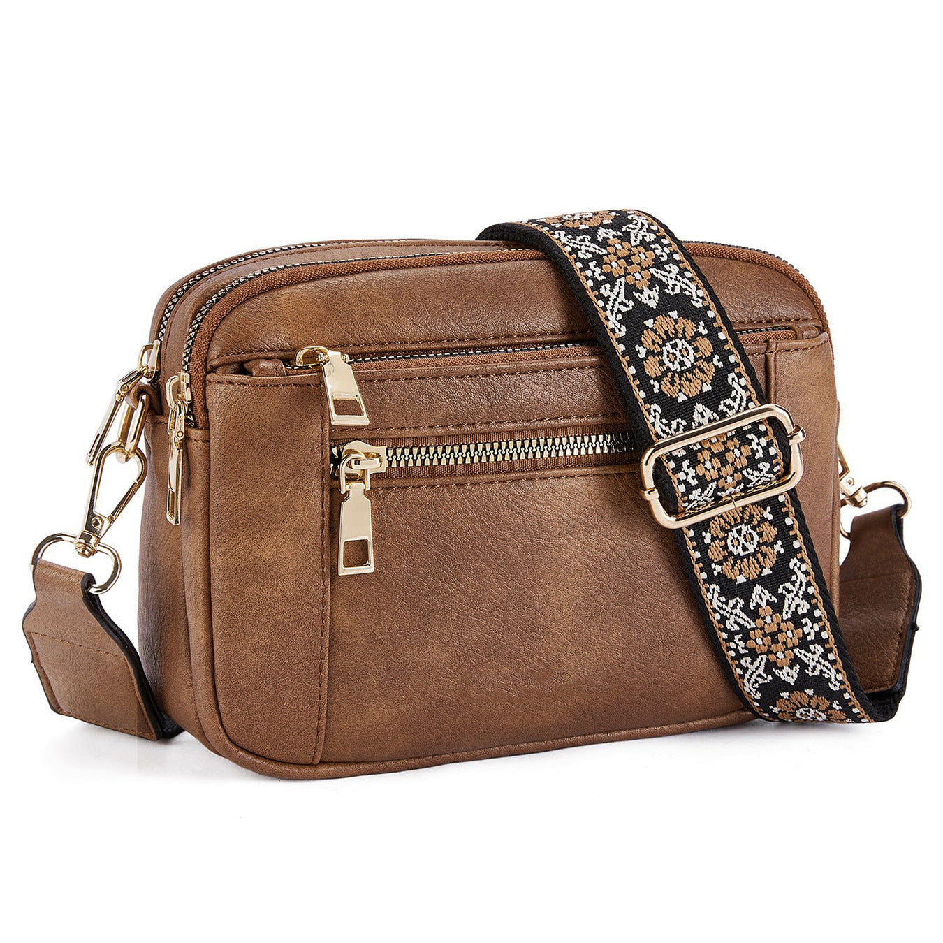 Tan crossbody bag with triple zippers and floral patterned strap with buckle.