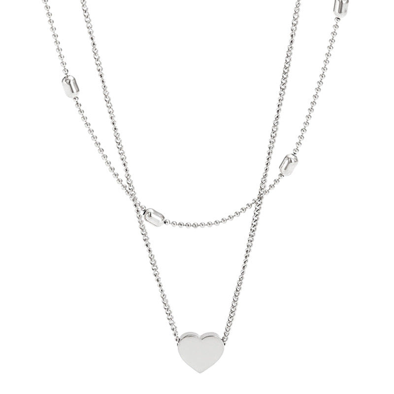 Silver heart pendant layered necklace with thin chain and small bar details