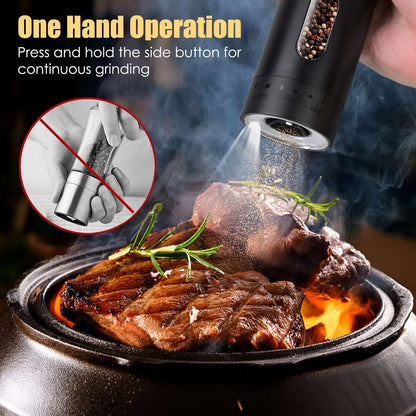 Black rechargeable electric pepper grinder held overhead with grinding spout releasing pepper