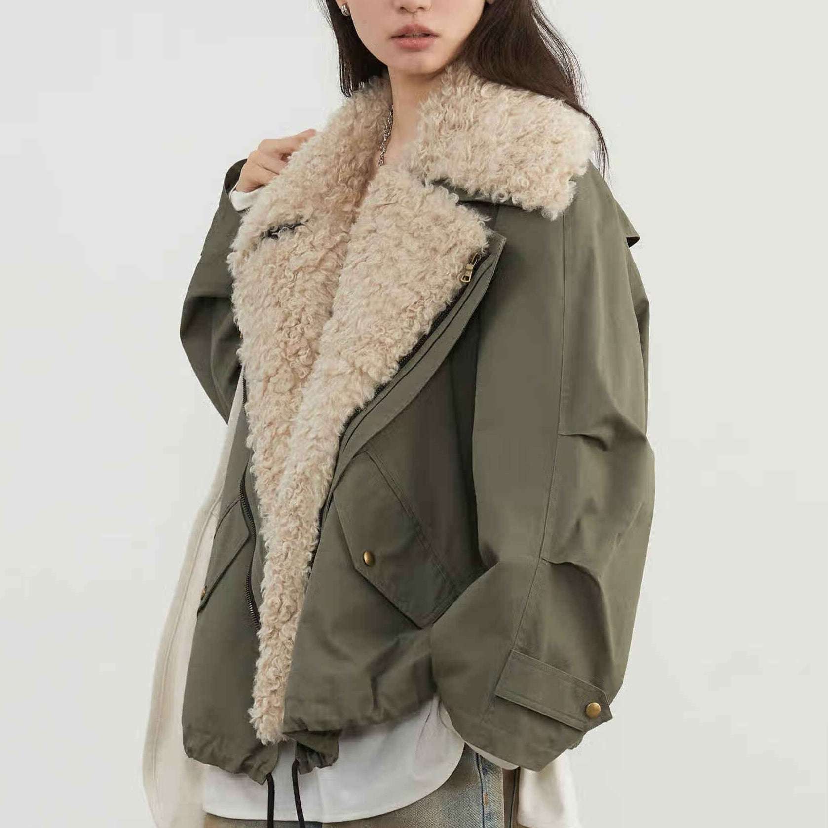 Women’s olive green jacket with cream sherpa collar, flap pockets, and front snap closure