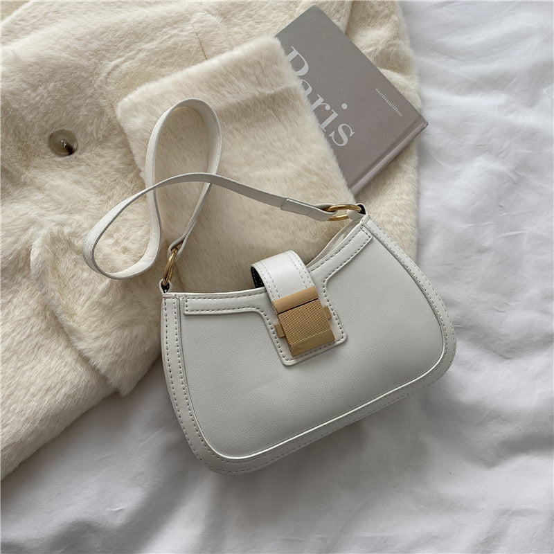 White PU shoulder bag with gold-tone clasp and adjustable strap, compact curved design.