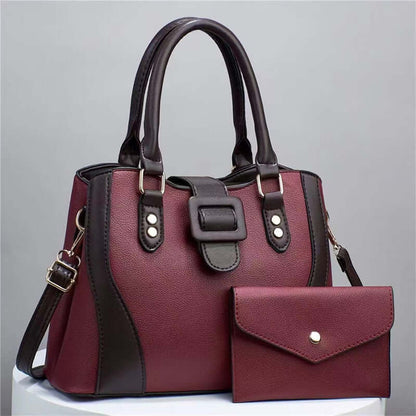Red tote bag with black side panel and matching envelope clutch pouch