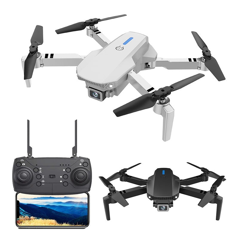 White quadcopter drone with four propellers and handheld remote controller with display