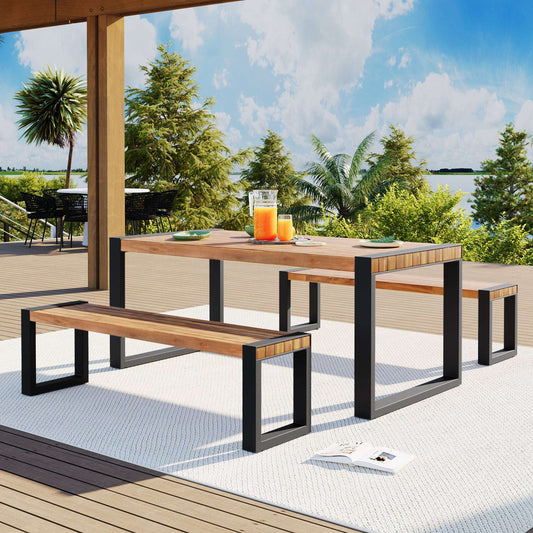 3-piece natural acacia wood dining set with two matching benches and a steel-framed table on a modern outdoor patio.