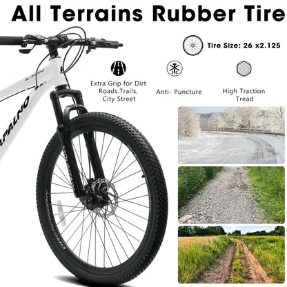 Front wheel with black knobby all-terrain tire and disc brake on a white bike