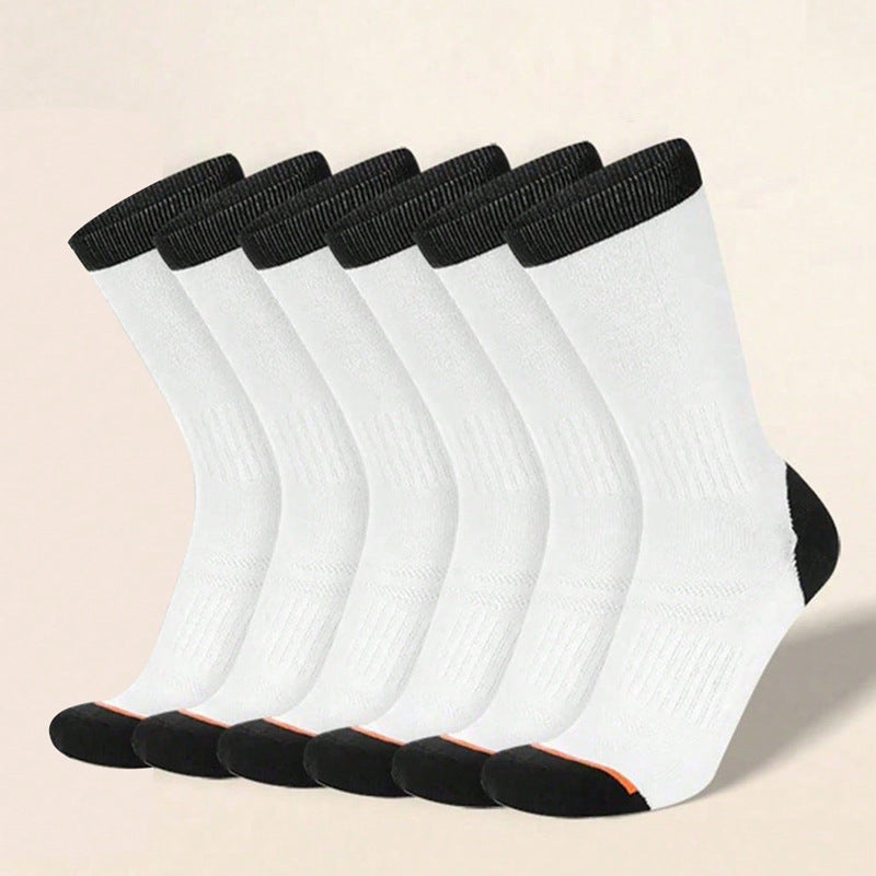 Set of six white socks with black tops on a beige background