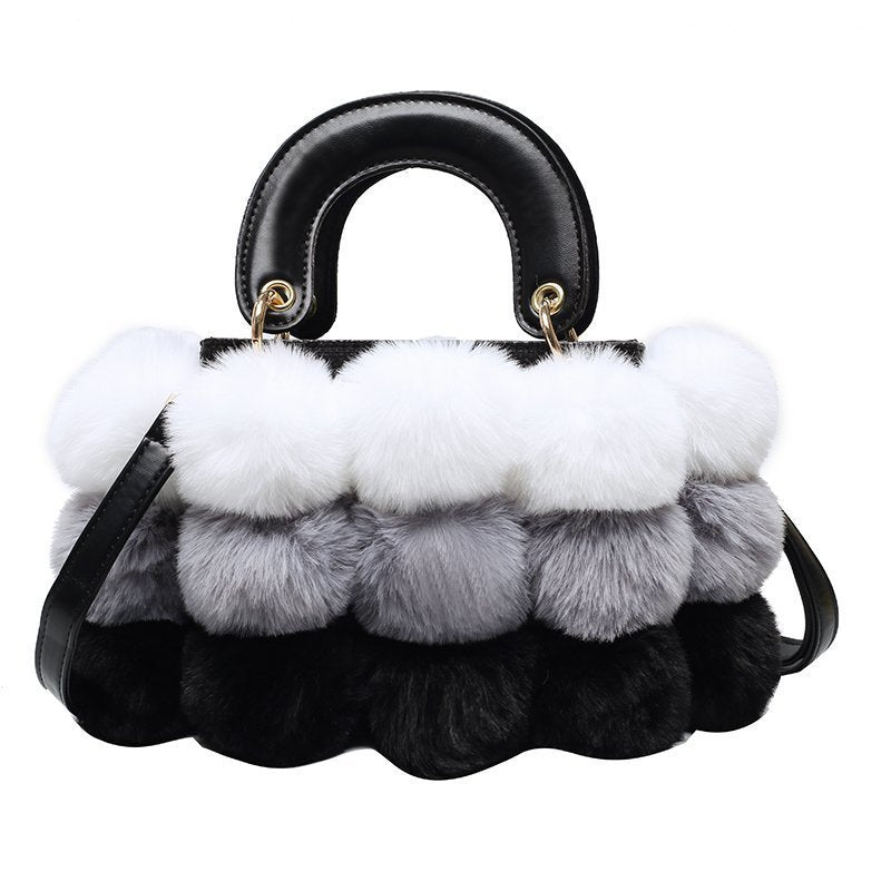Plush shoulder bag with black handle and layered white, light gray, and dark plush tiers