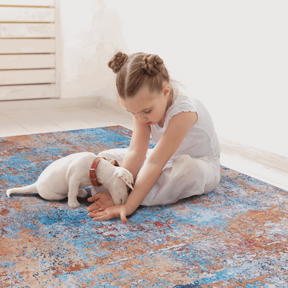 Washable indoor area rug in blue, orange, and gray abstract pattern