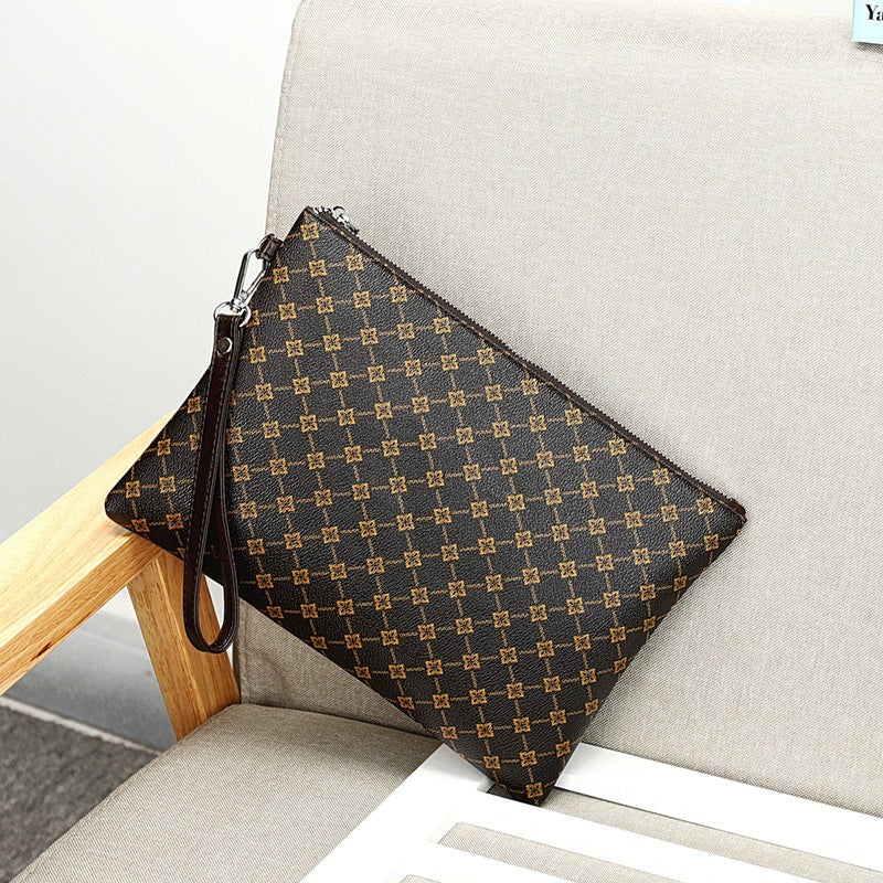 Brown patterned zip-top clutch bag with wrist strap and repeating monogram print