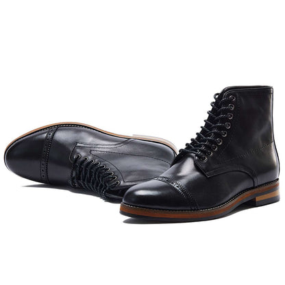 Pair of black leather boots on a white background