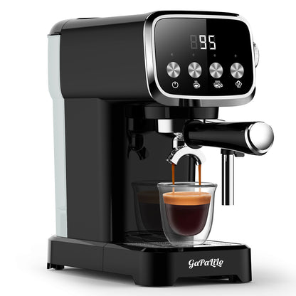 Black and white compact espresso machine with steam wand and filled glass beneath spout