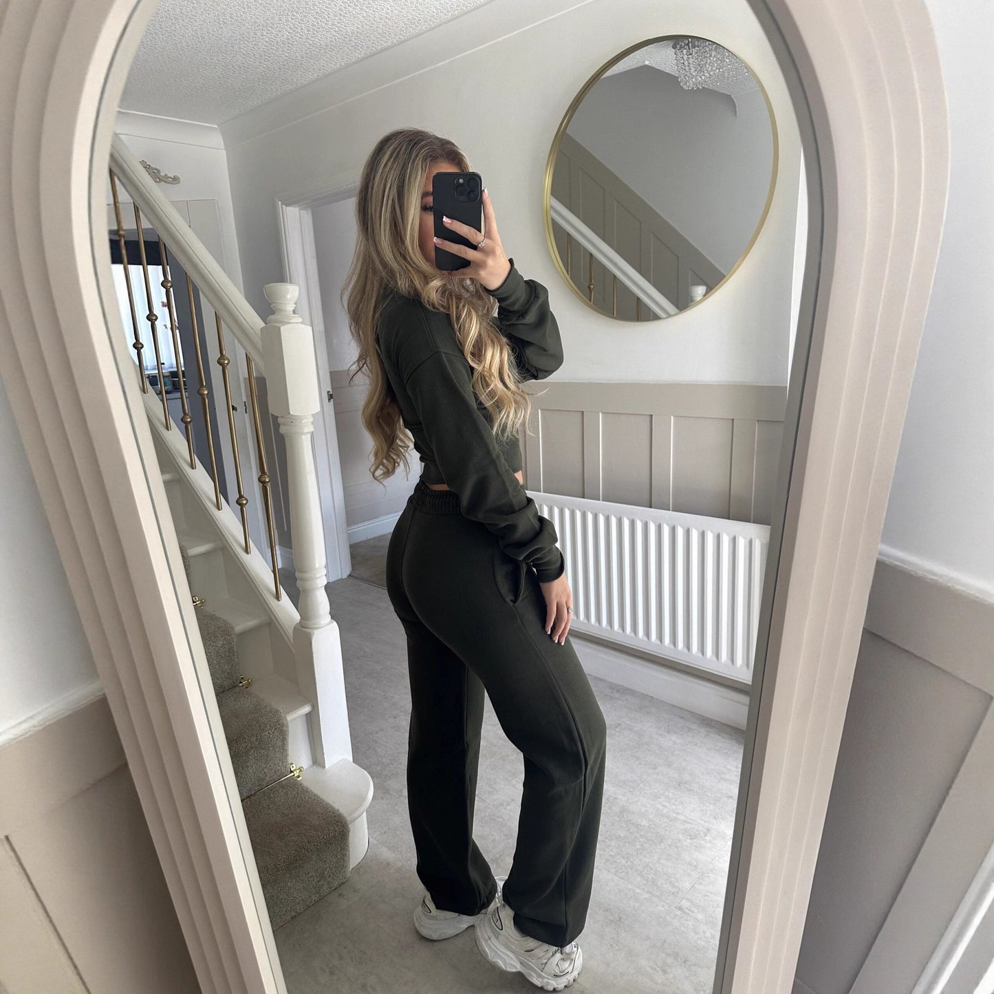 Women’s zip-front sweatshirt and jogger set in black, two-piece outfit.