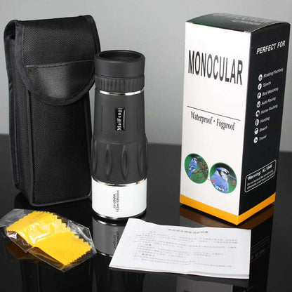 Monocular with carrying case, cleaning wipes, and packaging on a reflective surface.
