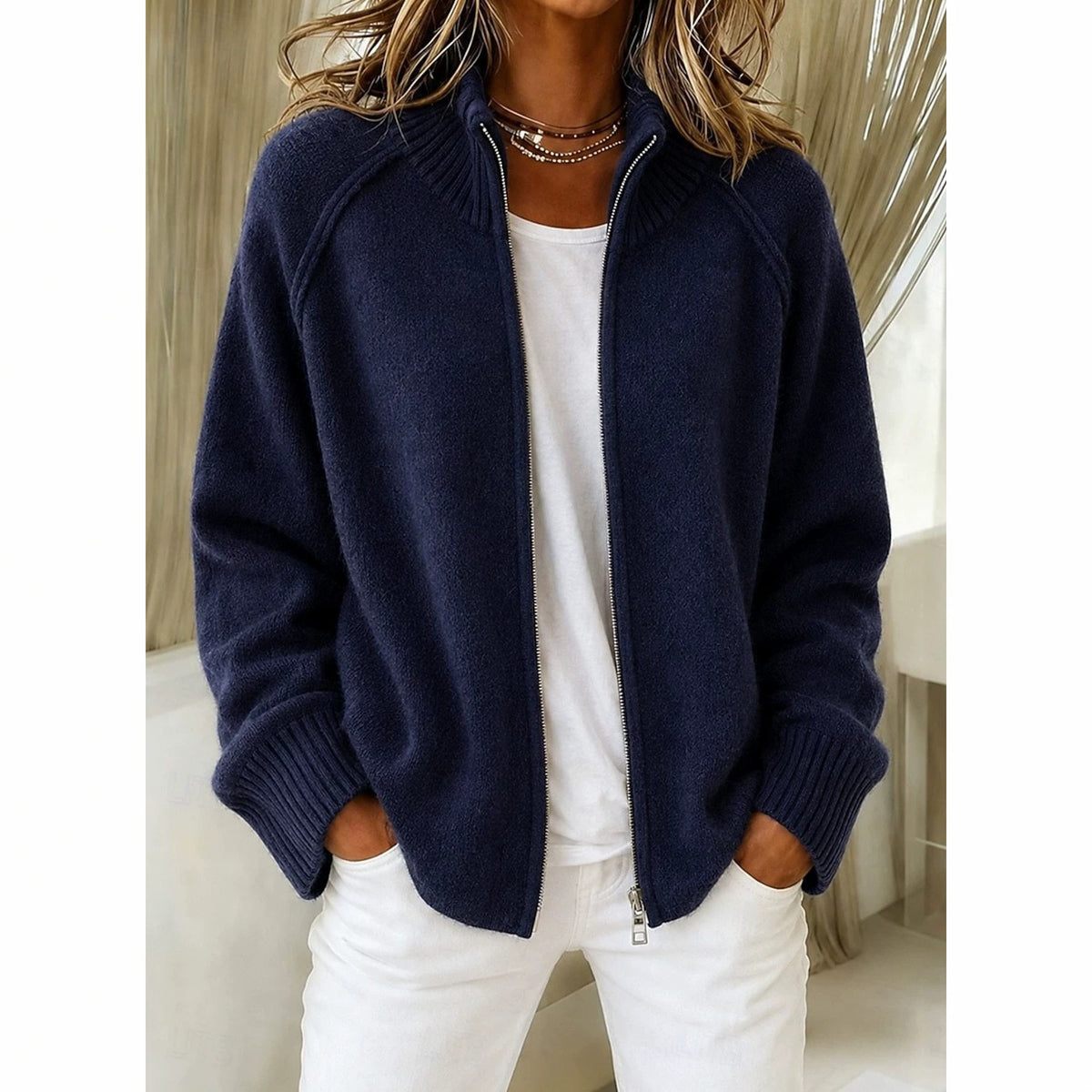 Navy knitted cardigan with stand collar and front zipper, long sleeves, ribbed cuffs