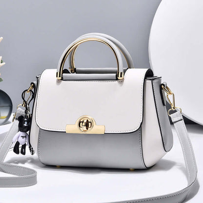 Lightweight crossbody bag in light gray, top handle and flap with gold clasp