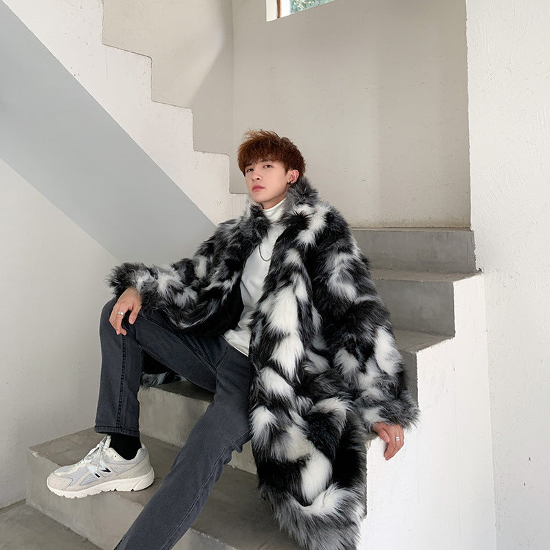 Person wearing a black and white fur coat sitting on a staircase.