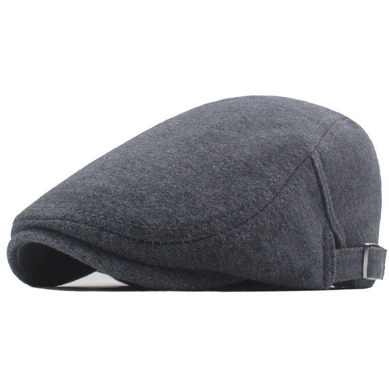 Dark gray newsboy cap front side view with curved brim and adjustable strap