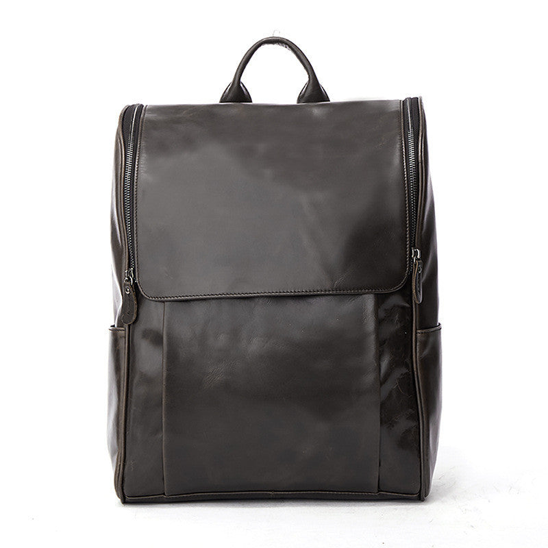 Dark leather laptop backpack with top handle, front flap, and two-panel front