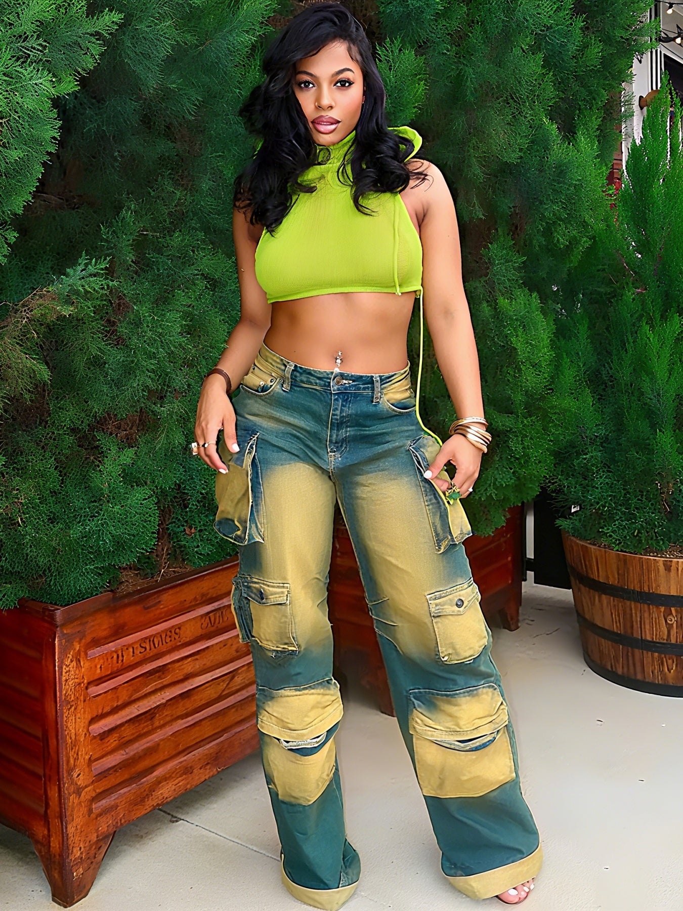 Loose-fitting green workwear jeans with cargo pockets, stitched patches, and distressed finish