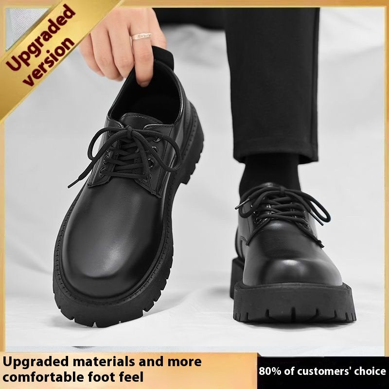 Black lace-up leather boots with thick lug sole, hand holding one boot