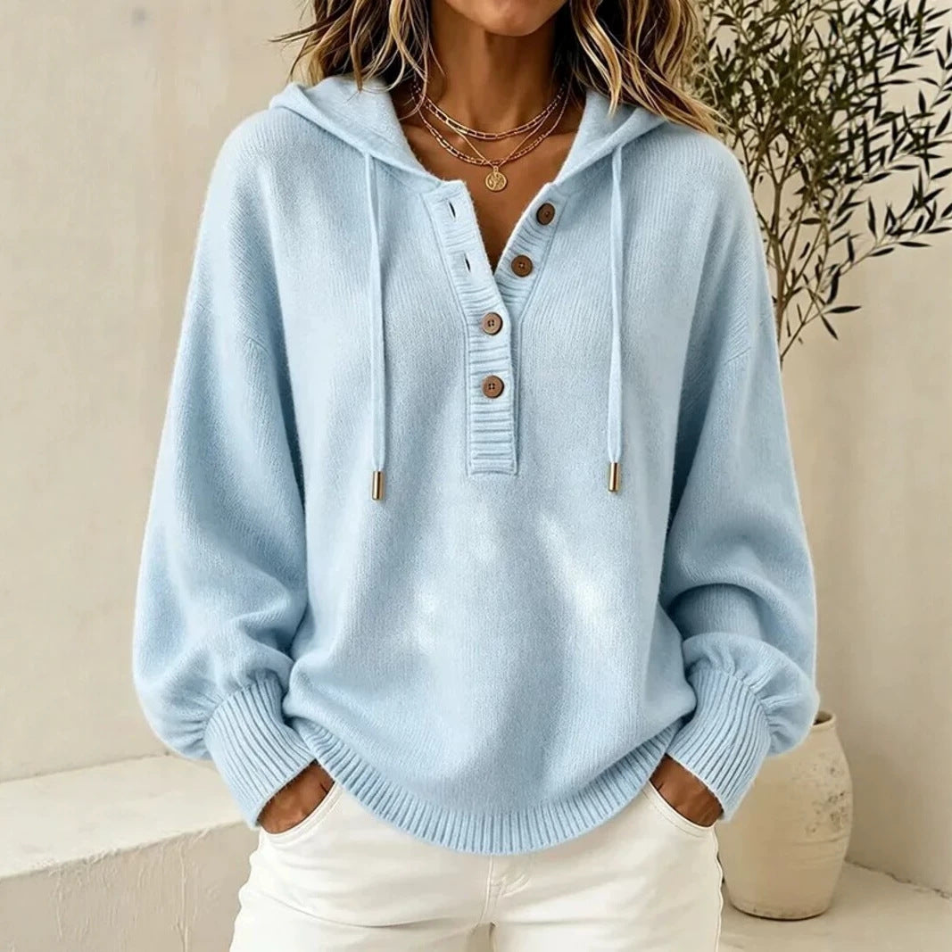 Light blue hooded knit sweater with button placket, drawstring cords, and ribbed cuffs