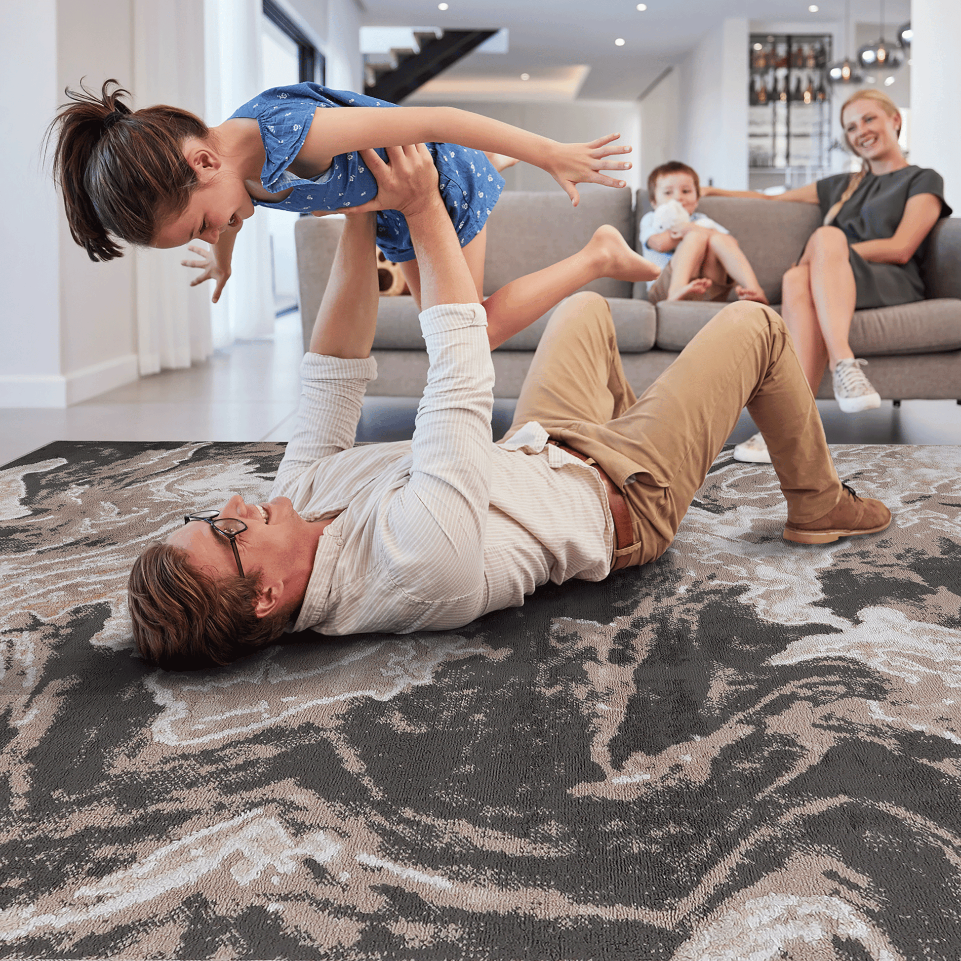 Abstract area rug with beige and light brown abstract swirls on dark gray