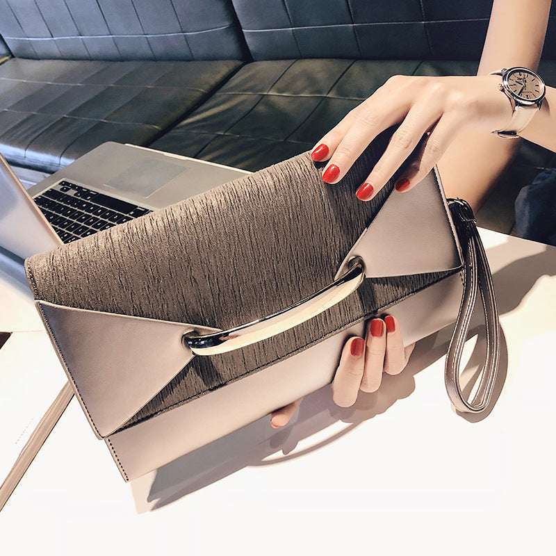 Champagne gold clutch bag with metal clasp and wrist strap