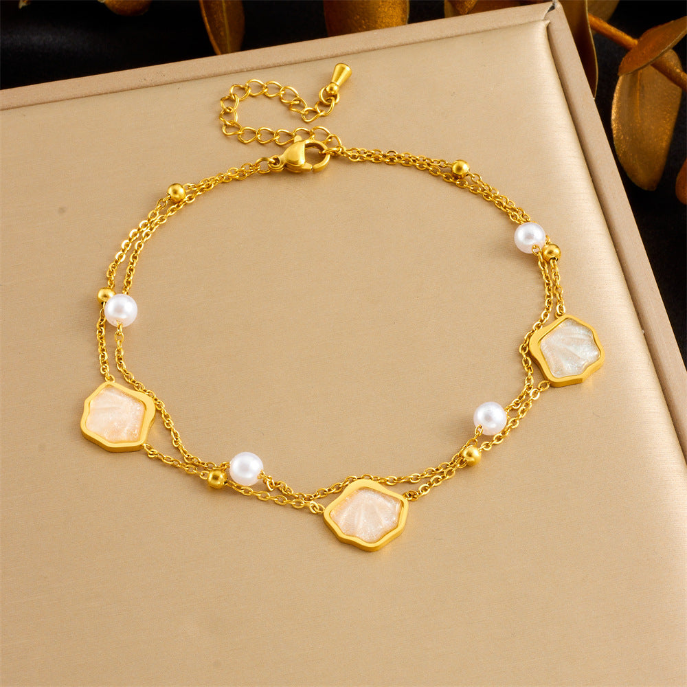 Gold-tone anklet with white inlay geometric charms and pearl beads