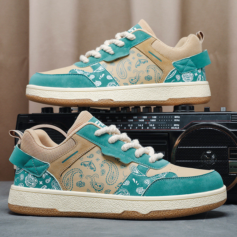 Low-top sneakers with teal canvas pattern, beige toe, and white lace-up detail