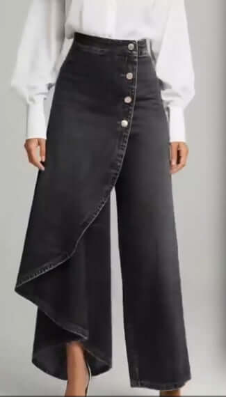 Black denim straight-leg pants with asymmetrical ruffle overlay and front button placket