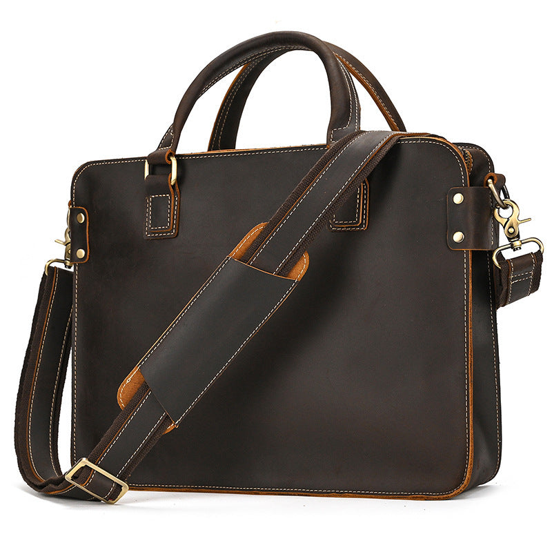 Brown leather briefcase with top handles, crossbody strap, buckle hardware