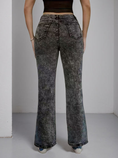 High-waisted dark jeans, wide flare cut, back view with side buckle hardware