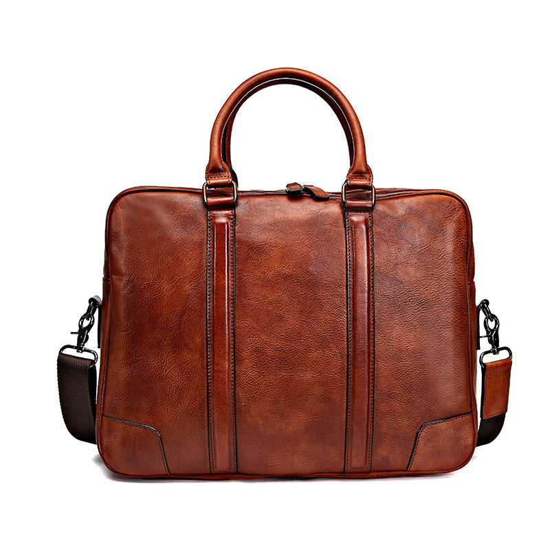 Light brown leather briefcase with top handles and crossbody strap attachments