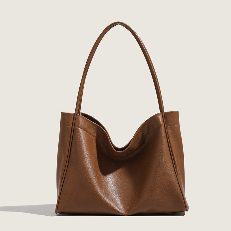 Coffee-brown leather tote bag with dual handles, open top and draped center