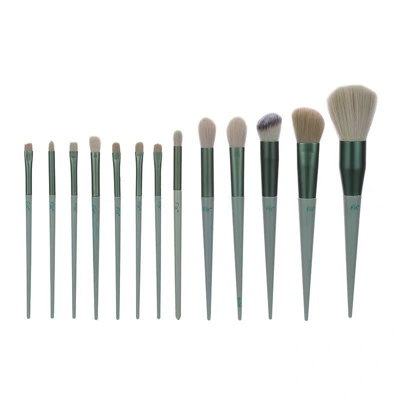 Makeup brush set with teal-green handles and soft beige bristles, arranged in a row.