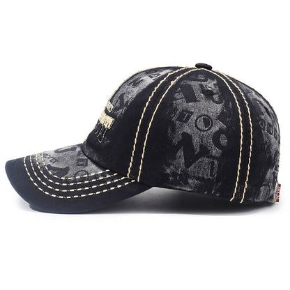 Washed black baseball cap with front graphic, tan contrast double-stitched seams