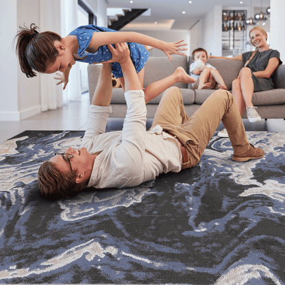 Abstract dark gray and light blue runner rug with cream swirls and cloud-like motif
