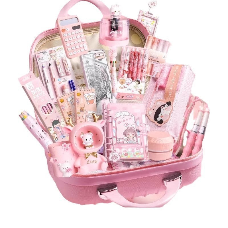 Pink stationery box set with organized compartments and writing tools, open view