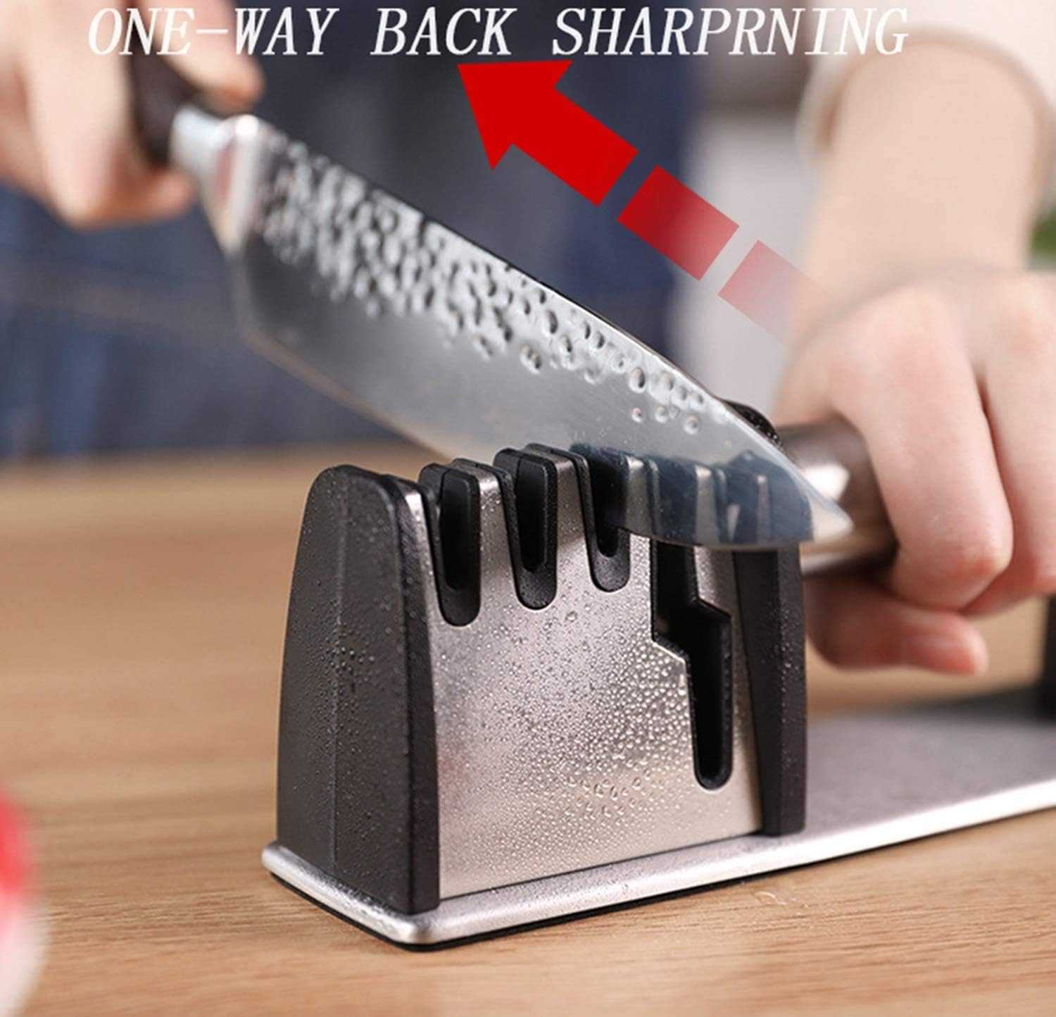 Close-up of black sharpening slots on silver base with knife positioned