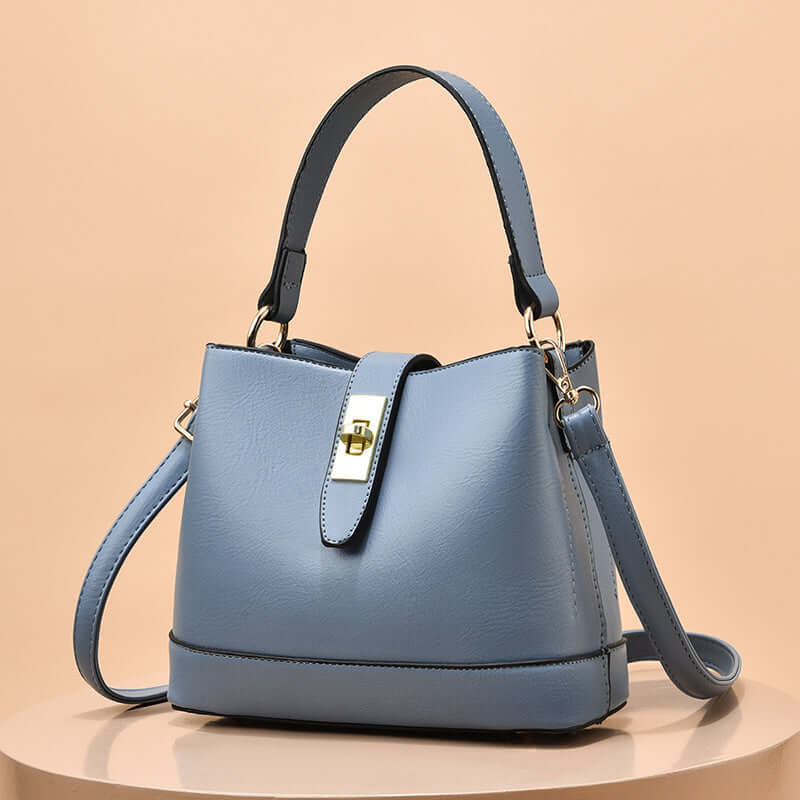 Powder blue tote handbag with shoulder strap and gold clasp hardware