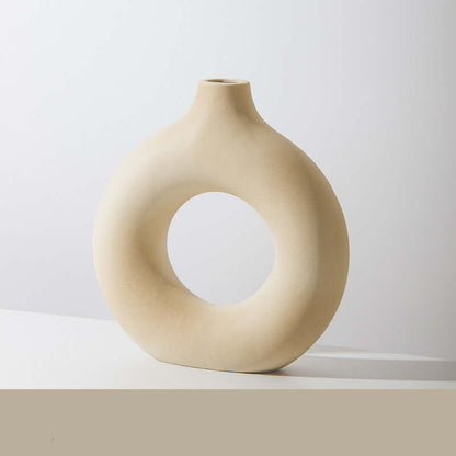 Cream ceramic vase with large circular cutout and short neck opening