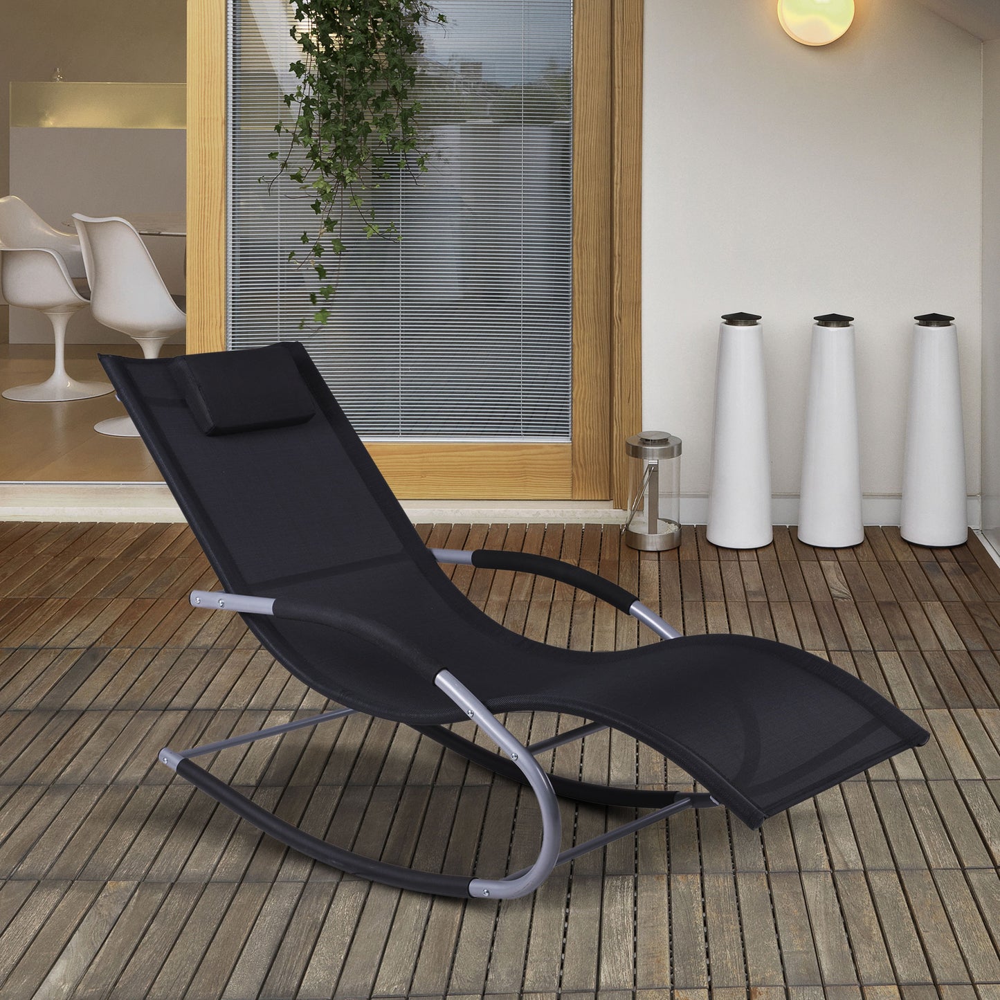 Black outdoor rocking lounge chair with curved rock base and padded head pillow