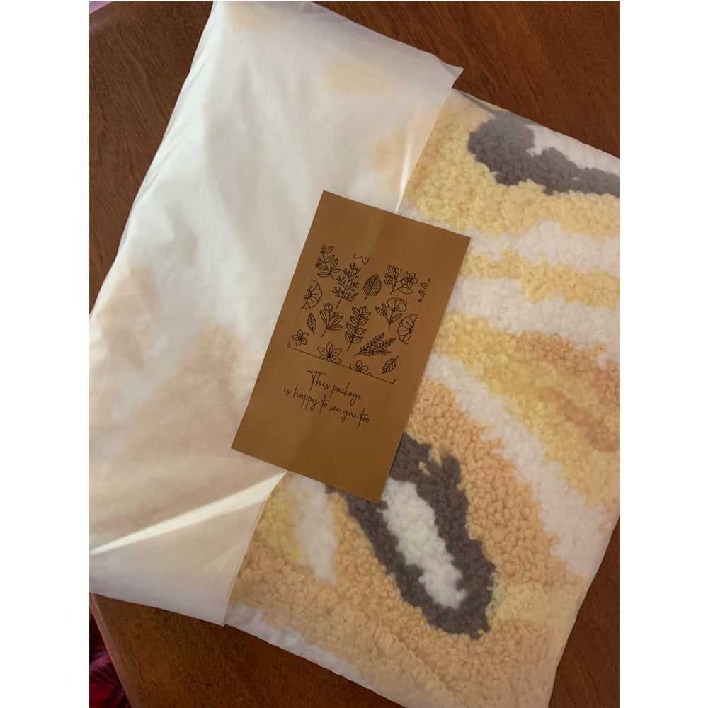 Yellow and white lemon slice bath mat with speckled textured surface, folded view