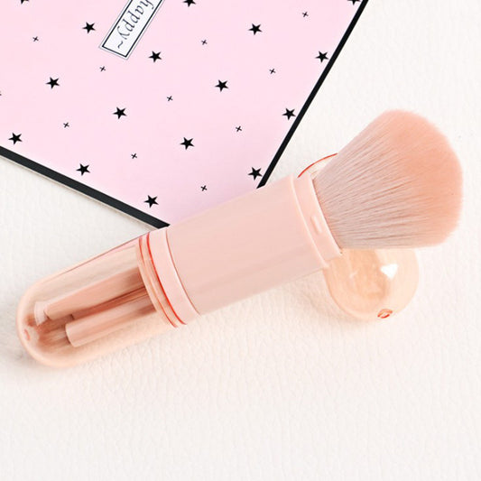Makeup brush with pink handle and white bristles on a light background