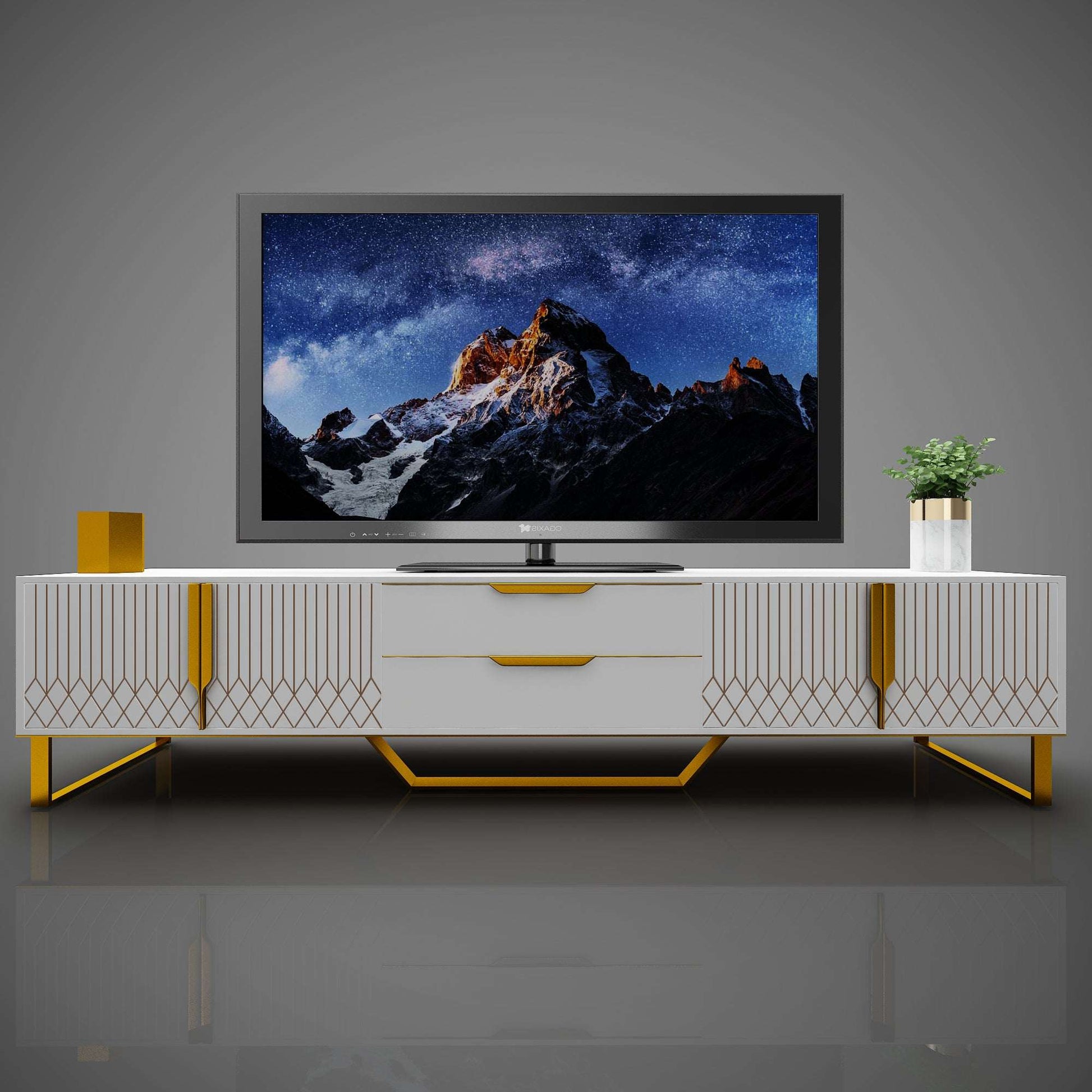 Front view of white TV console with diamond-carved doors, drawers, and gold metal legs