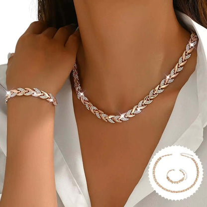 Rhinestone leaf necklace and bracelet set in rose gold tone, on model neckline and wrist.