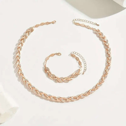 Rhinestone leaf jewelry set in rose gold tone: necklace and bracelet on display.