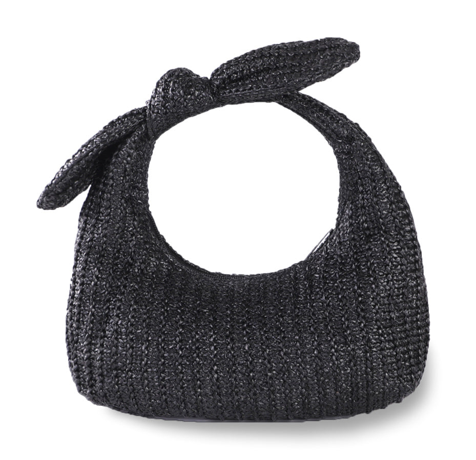 Straw bow clutch handbag in dark charcoal with tied bow handle and round opening