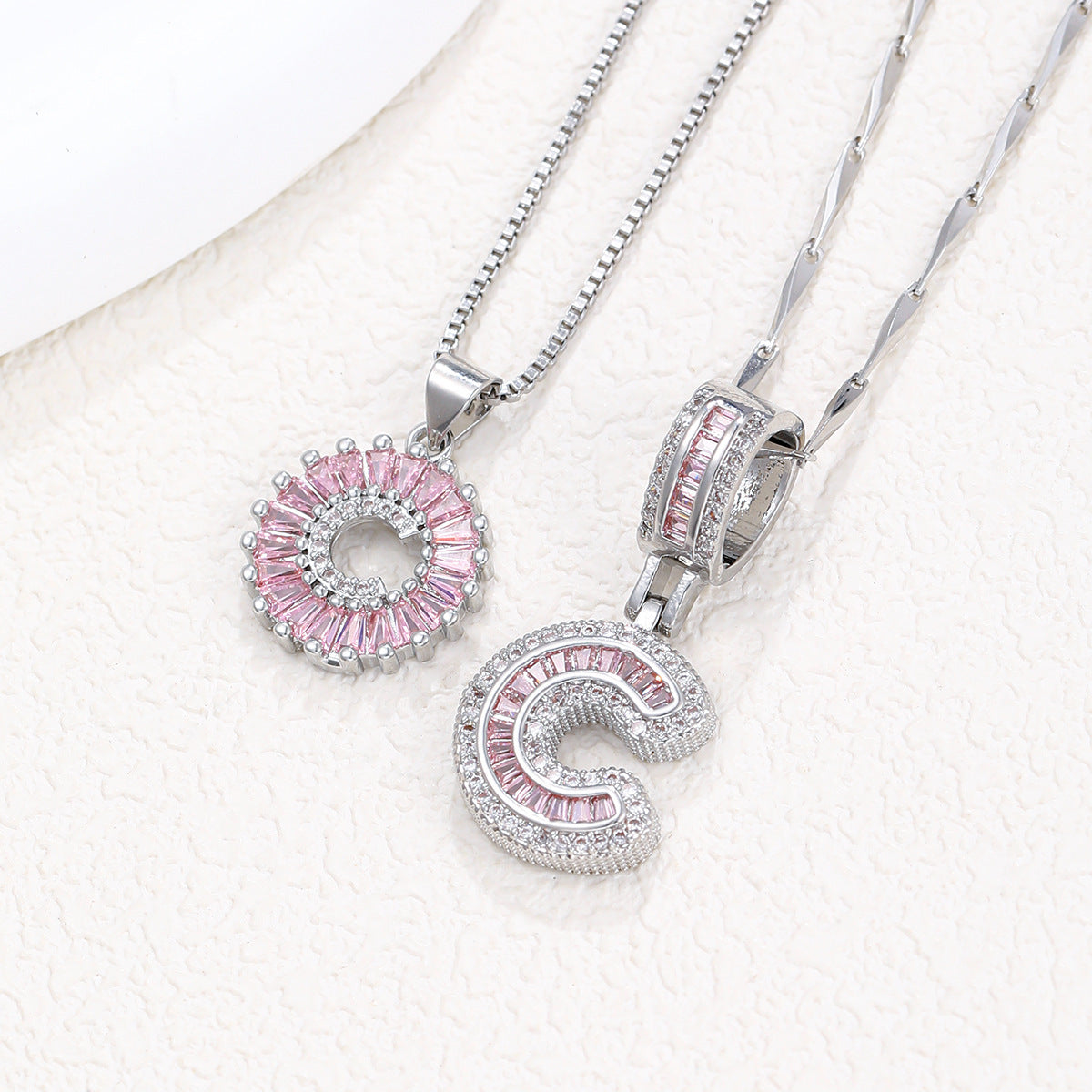 Silver-tone pendant necklace set with pink crystal flower halo and large letter charm