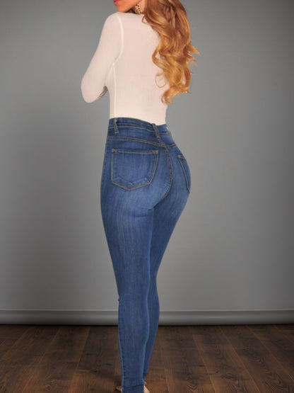 Women’s mid-blue high-waisted buckle jeans, back view with belt loops and pocket seams